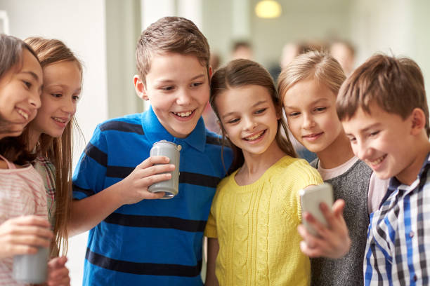 istock group of school kids with smartphone and soda cans 857774668