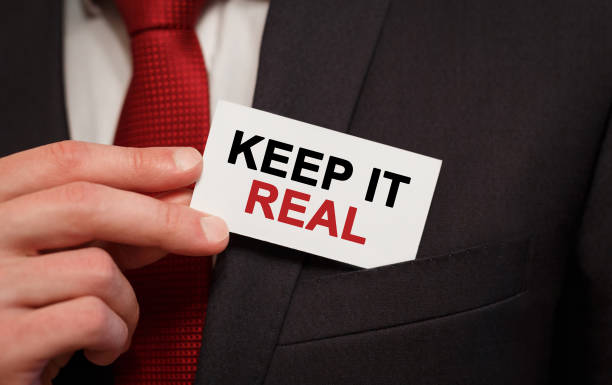 Businessman putting a card with text Keep It Real in the pocket Businessman putting a card with text Keep It Real in the pocket real symbol stock pictures, royalty-free photos & images