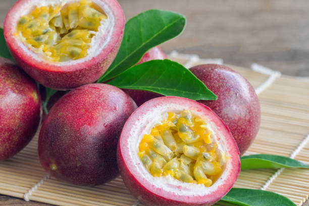 istock Close up fresh passion fruit stack on wood table in side view. Passion fruit is popular tropical fruits. Ripe passion fruit so juicy sweet and sour suitable make dessert for summer time. 857777798