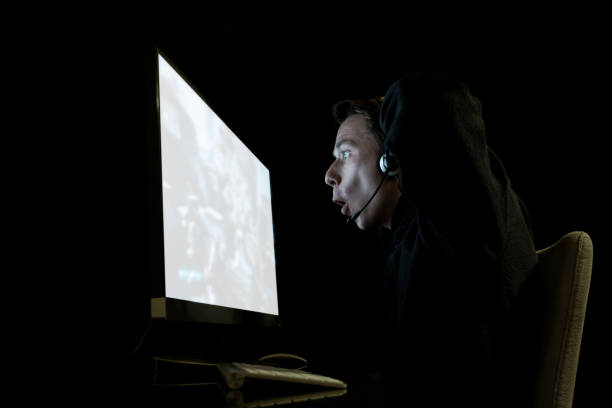 istock Young man playing computer games in dark room 857778168