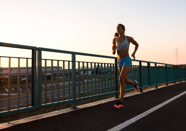 istock Young determined athletic woman jogging on the street. 857778352