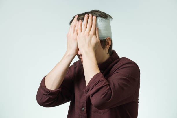 istock Man with bandage on his head 857778874