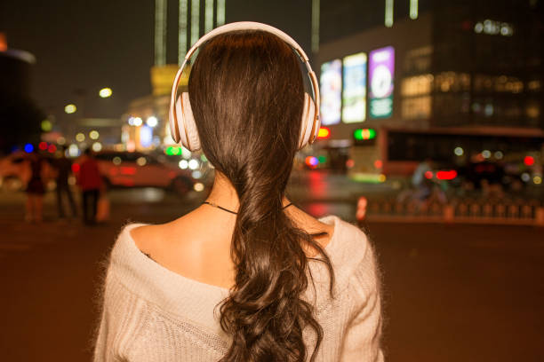 istock Night beautiful girl back in busy streets 857779022
