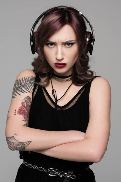 istock Grumpy young woman in big headphones 857782126