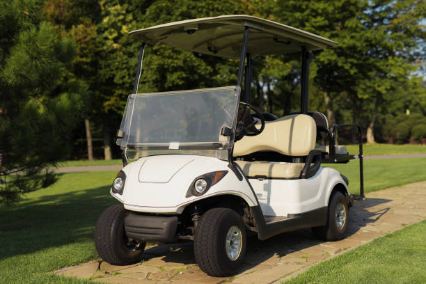 istock White golf cart on the stone path in the golf club 857782494