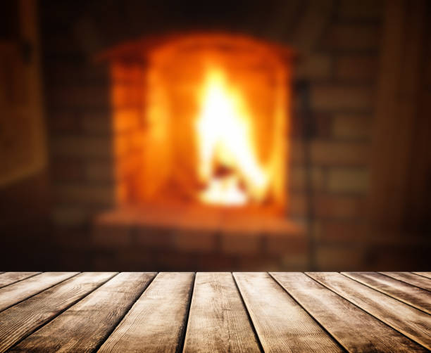 istock Old wooden table and blurred of fireplace 857782602