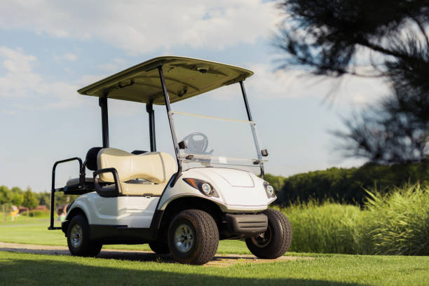istock White golf cart stands on a green background 857782618