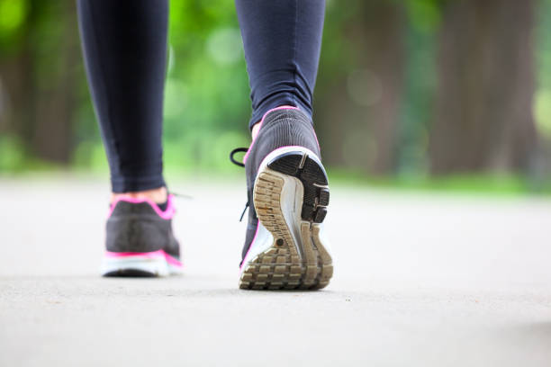 istock Running shoes on road. Rear view. 857785362