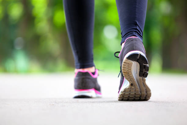 istock Running shoes on road. Rear view. 857785520