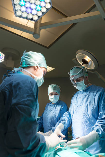 istock Concentrating surgeons performing operation in operating room 857793346