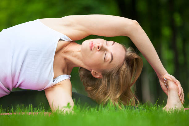 istock Young woman is stretching in the park. 857794198