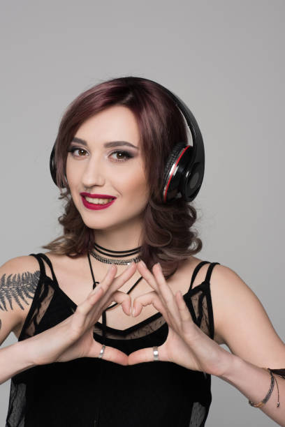 istock Young woman making heart sign 857795436