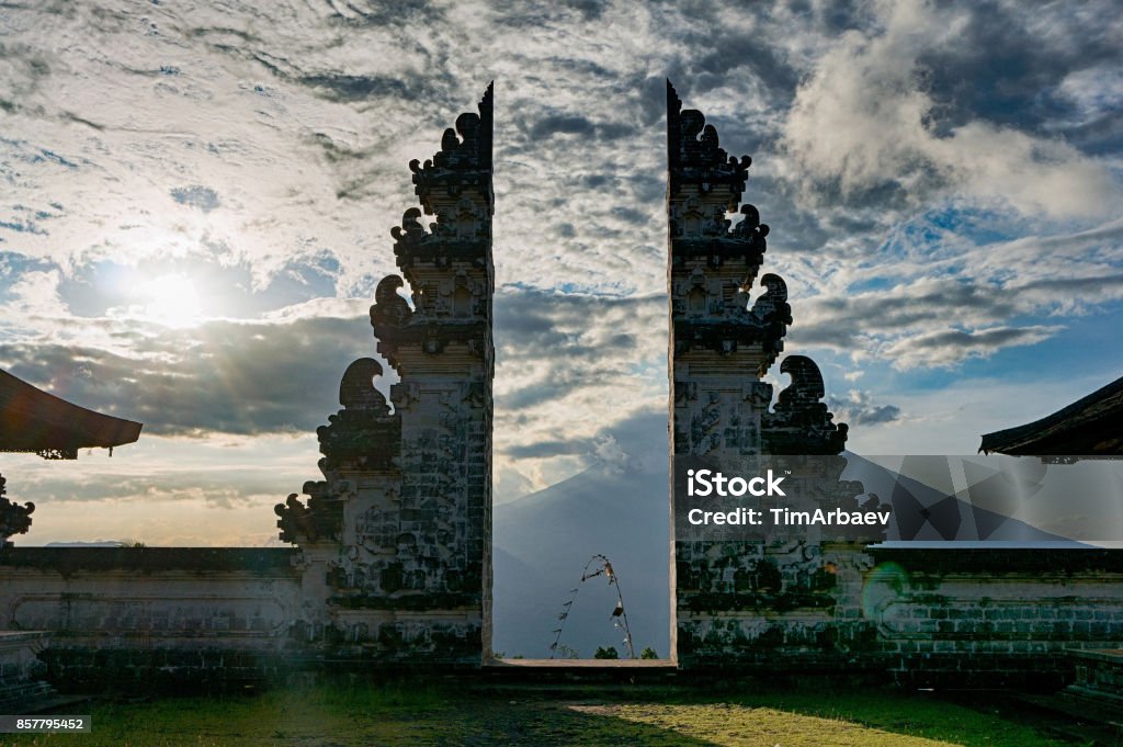 Traditional gateway into a balinese temple Pura Luhur Lempuyang Split gateway wich is called candi bentar in the acient balinese temple Pura Luhur Lempuyang, with stratovolcano Gunung Agung on the background, Bali, Indonesia Temple - Building Stock Photo