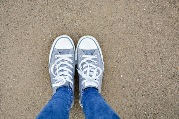 istock Standing with two shoes on sand as seen from above 857797744