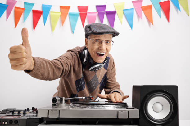 istock Senior playing music on turntable and making thumb up sign 857797876