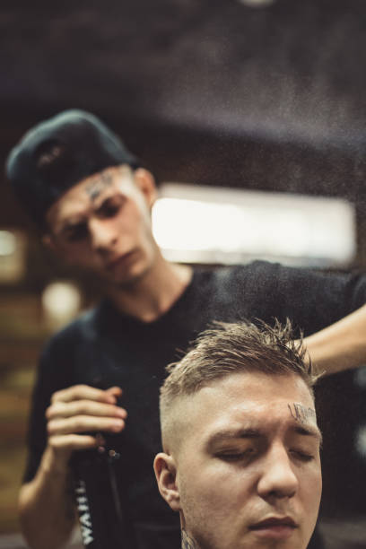 istock Stylist grooming client in barbershop 857798890