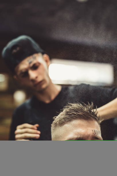 istock Stylist grooming client in barbershop 857801938