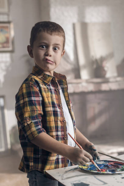 istock Young boy goofing around in an atelier 857810390