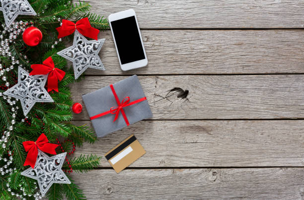 istock Gift box on wood background with phone and credit card 857813670