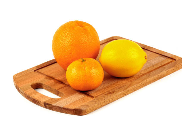 istock Mandarin, lemon and orange on a wooden cutting board on a white background. 857813848