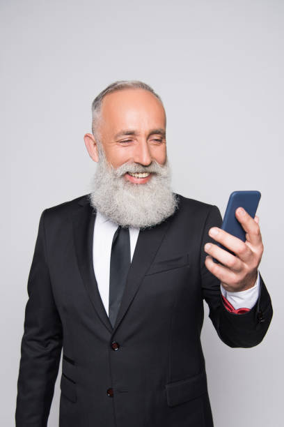 istock senior man looking at smartphone 857816834