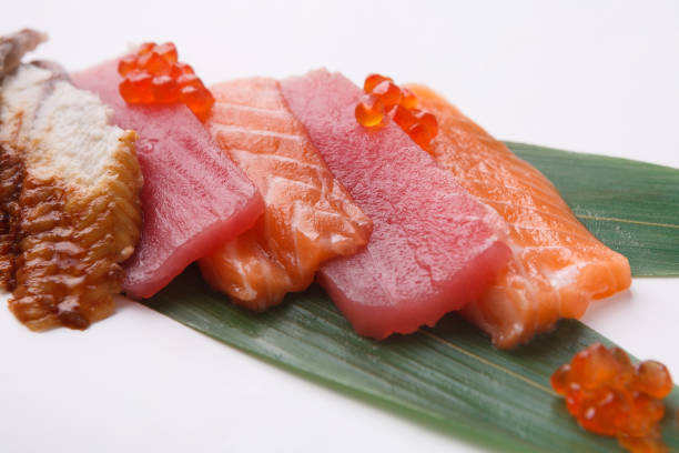 istock Sashimi set on bamboo leaf isolated at white, closeup 857817060