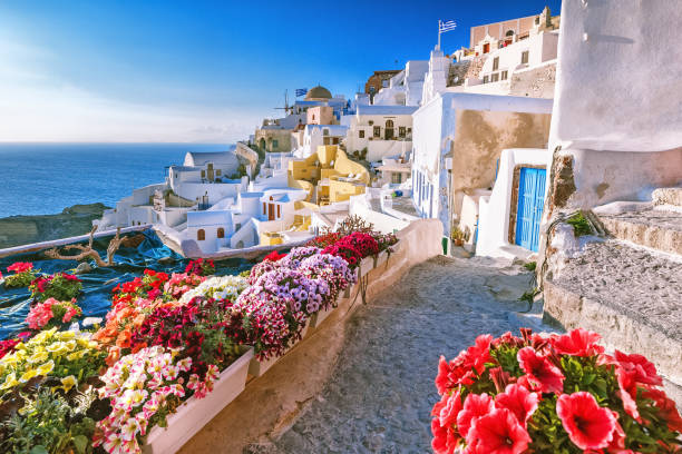 Skyline of Oia, traditional white architecture with windmills, greek village of Santorini, Greece. Santorini is island in Aegean sea, famous summer resort. Skyline of Oia, traditional white architecture with windmills, greek village of Santorini, Greece. Santorini is island in Aegean sea, famous summer resort. fira santorini stock pictures, royalty-free photos & images
