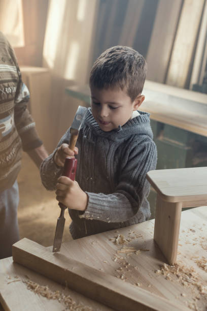 istock Grandfather and Grandson Doing Carpentry 857817878