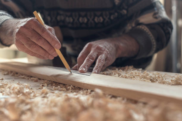 istock Close-up hands of Senior Carpenter Measuring 857818108