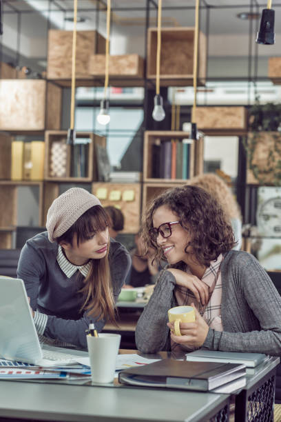 istock Two female colleagues having coffee break together 857821468