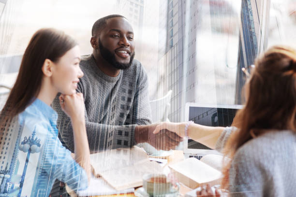 istock Faithful friends sitting and shaking hands 857821914