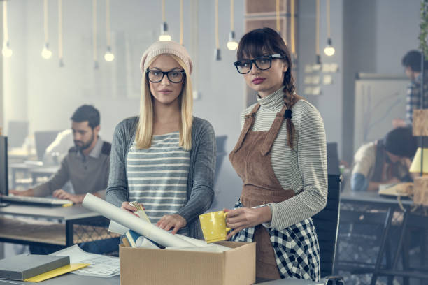 istock Young woman got fired and her friend help her with packing 857825080