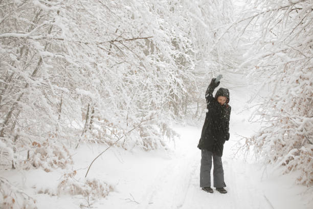 istock Young woman on a walk in winter nature 857827920