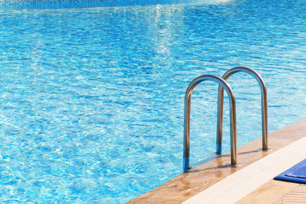 istock Blue swimming pool with stair at hotel 857827996