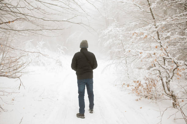 istock man in snowy winter forest 857828638