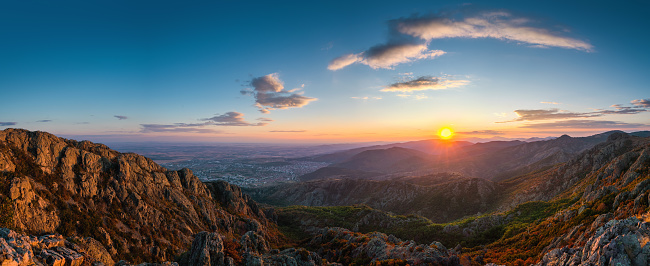 Beautiful sunset over the mountain hills and city, Aerial panorama