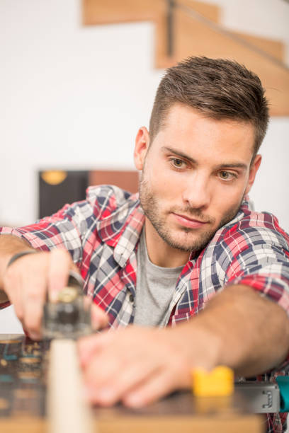 istock Man working on wood planks for home-improvement 857831434