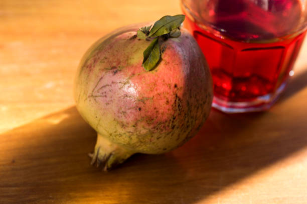 Close-up of pomegranate juice with fresh fruit on the table
