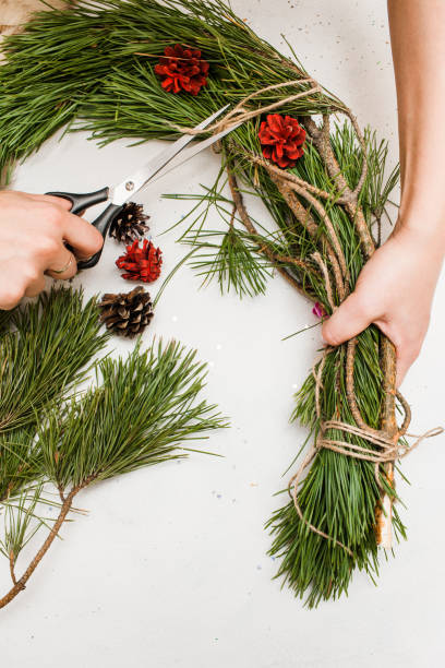istock Christmas wreath making by woman 857832430