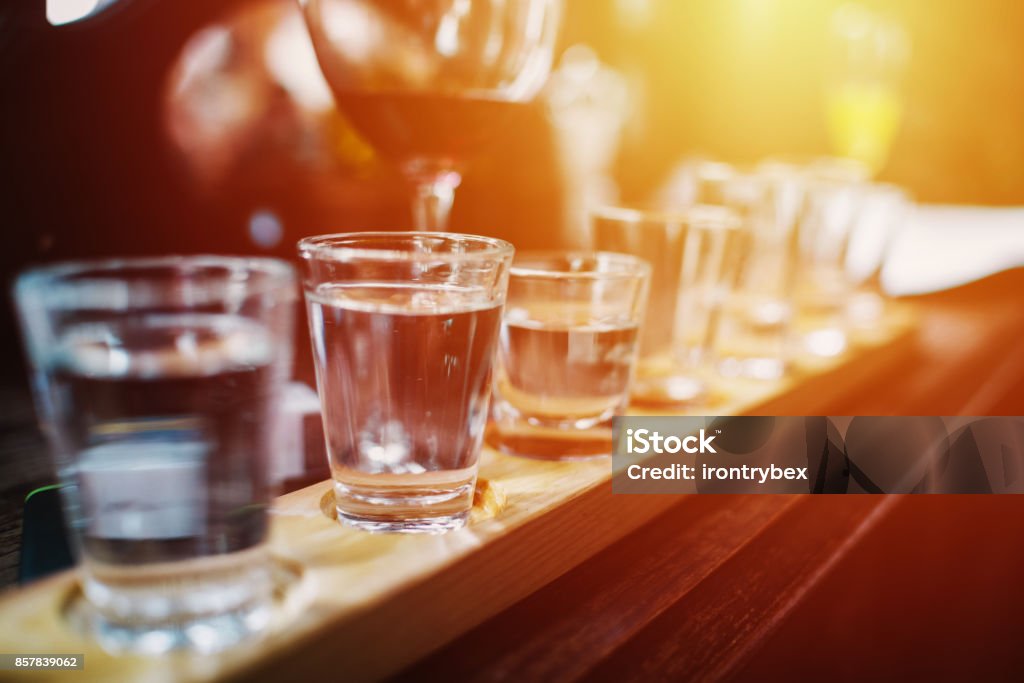 Close up on Vodka shots and other alcohols in a row Alcohol Abuse Stock Photo