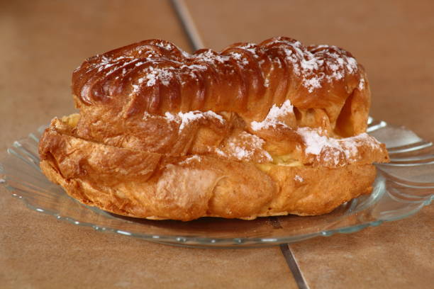 istock Eclair filled with pastry cream (custard) and topped with icing sugar 857839234