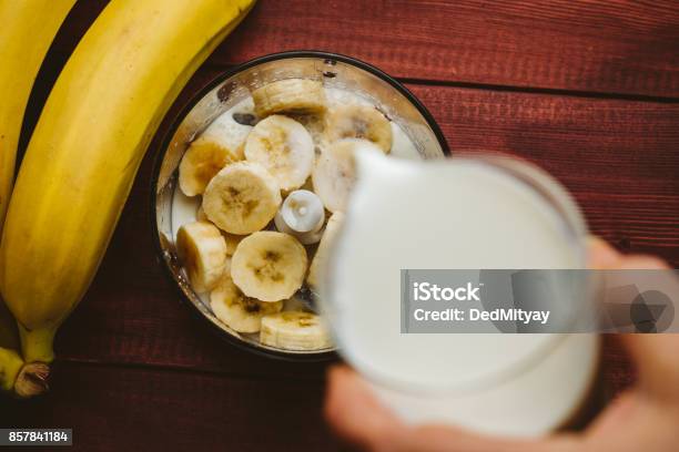 Pouring Milk In Blender Over Pieces Of Bananas Banana Smoothie Top View Stock Photo - Download Image Now