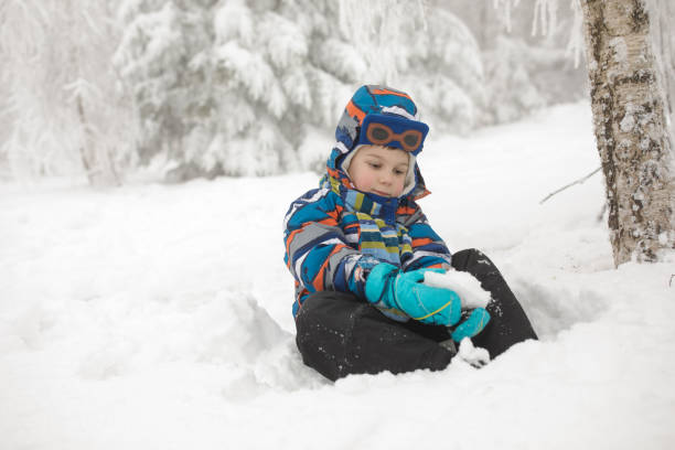 istock Happy little boy playing in snow 857841850