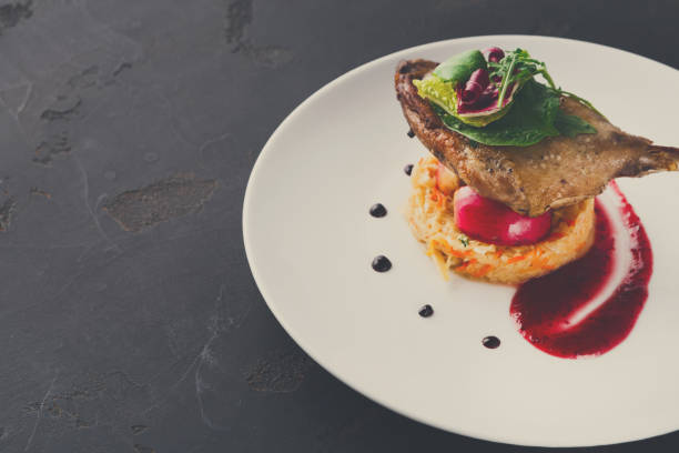 istock Restaurant meals. Duck confit with vegetables on black backgroun 857842146