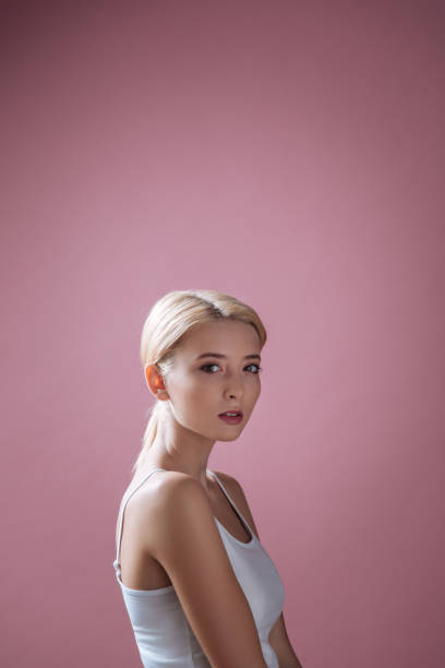 atrakcyjna dziewczyna jest w profesjonalnym studio - vertical studio shot indoors pink zdjęcia i obrazy z banku zdjęć