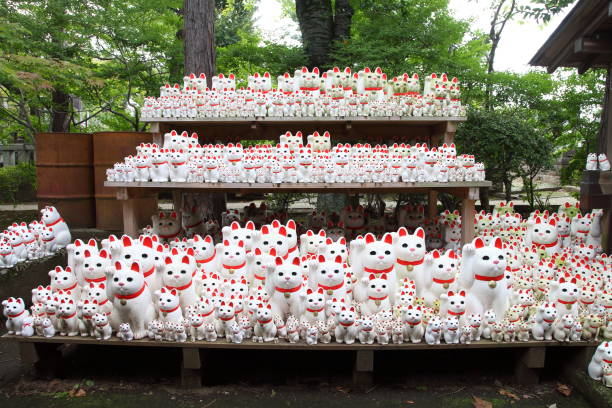 Tons of small dolls "the beckoning cat" known as maneki neko at Gotokuji in Tokyo, JAPAN. Tokyo, Japan- October 1, 2017: Gotokuji Temple is a Buddhist temple that is said to be the birthplace of the beckoning cat known as maneki neko. You can see these small statues, which portray a cat sitting up and beckoning with its front paw. setagaya ward stock pictures, royalty-free photos & images