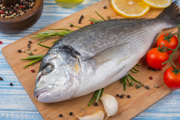 istock Fresh dorado on blue wooden background 857852186
