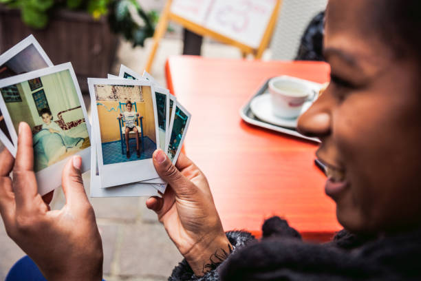 istock Young woman looking at instant camera photo frames 857853958