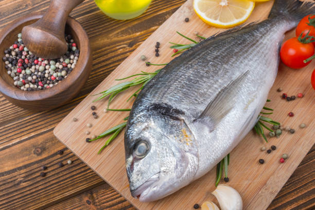 istock Fresh dorado on wooden background 857853966