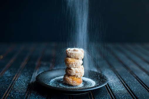 Sweet and sugary donuts on a table.